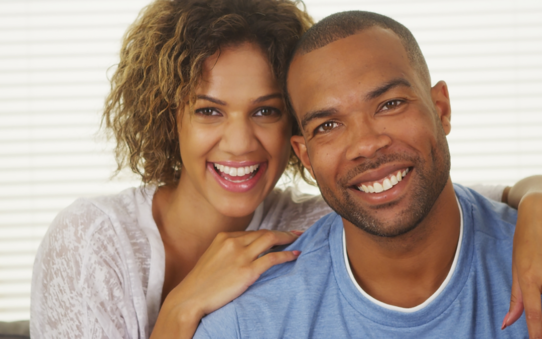 Couple with beautiful smile after cosmetic dental treatment